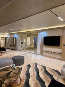 a large living room with a large flat screen tv at Cety abartment hotel in Giza