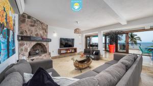 a living room with a couch and a fireplace at Casa Bahía Linda by Kivoya in Puerto Vallarta
