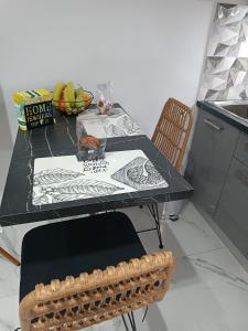 a table in a kitchen with a plate of fruit on it at Heraklion Central Studio MaZa1 in Néa Alikarnassós +5 photos