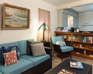 a living room with a blue couch and a chair at Silver Heart Inn & Cottages in Independence