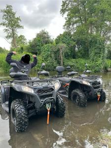 a person on a four wheeler in a river at Siedlisko Rawka in Doleck