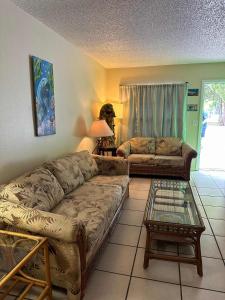 a living room with a couch and a table at Professor Rousseau's Manatee Bay in Crystal River