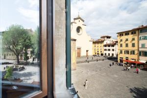 a view from a window of a city street at Santo Spirito Palace in Florence