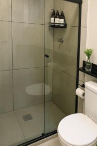 a glass shower stall in a bathroom with a toilet at Studio Moderno 401 Santa Casa UFRGS Estacionamento grátis in Porto Alegre +25 photos