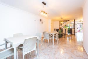 a dining room with white tables and chairs at Hotel Colores Boutique in Medellín +105 photos