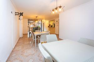 a dining room with white tables and chairs at Hotel Colores Boutique in Medellín