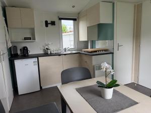 a kitchen with a table with a vase on it at wallerseehomes 110 in Baierham