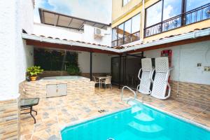 a house with a swimming pool and a patio at Hotel Colores Boutique in Medellín +40 photos
