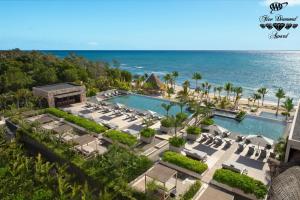 an aerial view of a resort with a pool and the ocean at Impression Moxché by Secrets - Adults Only in Playa del Carmen