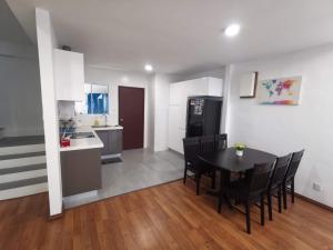 a kitchen and dining room with a table and chairs at Rainbow homestay 22 in Sandakan