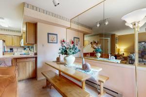 a living room with a table with a vase on it at Gold Dust F3 in Angel Fire