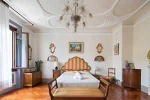 a bedroom with a bed and a coffered ceiling at Santo Spirito Palace in Florence
