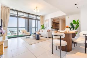a living room with a view of the ocean at Families & Groups Paradise - 3 min walk to Reem Central Park and Beach - 10 people - Big Balcony - High Floor in Abu Dhabi