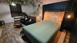 a bedroom with a bed and a living room at Botanica - Private Spa in Saint-Quentin