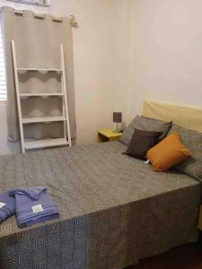 a bedroom with a bed with pillows and a ladder at Apto confortável cozinha, smart tv in Joinville