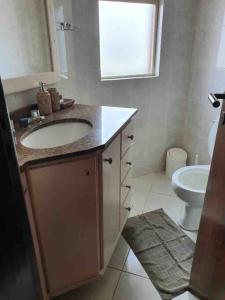 a bathroom with a sink and a toilet at Apto confortável cozinha, smart tv in Joinville