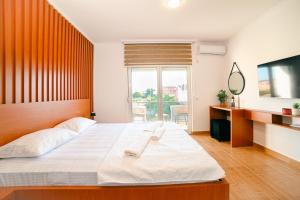 Ένα ή περισσότερα κρεβάτια σε δωμάτιο στο Hotel Ariana Lux