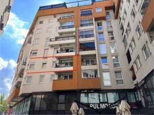 a tall apartment building with a sign on it at Aylin Apartman in Sarajevo