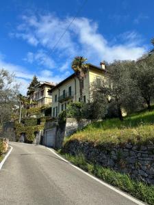 a house on the side of a road at Le Palm House has two bedrooms with the breathtaking view over lake Como in Perledo
