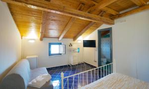 a bedroom with a bed and a tv in a room at Borgo Dei Saraceni - Suites & Apartments in Agropoli