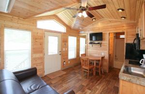 a living room with a couch and a table at Lake Conroe Two-Bedroom Cabin 13 in Willis