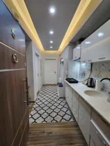 a large kitchen with two sinks and a hallway at Q Apart Daire 6 in Eskisehir