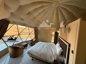 a bedroom with a bed and a large tent at Wadi Rum ZAAD luxury Camp in Wadi Rum