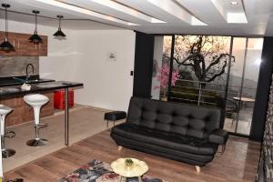 a living room with a couch and a table at Cabañas el encanto hotel boutique in Duitama
