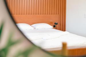 Ένα ή περισσότερα κρεβάτια σε δωμάτιο στο Hotel Ariana Lux