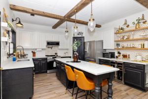 a kitchen with black and white cabinets and orange chairs at Private Room in Ballantyne in Charlotte