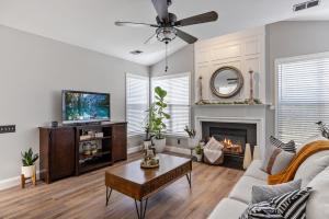 a living room with a couch and a tv and a fireplace at Private Room in Ballantyne in Charlotte