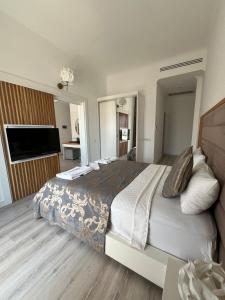 a large bedroom with a large bed and a television at Small Beach Hotel in Bodrum City +22 photos