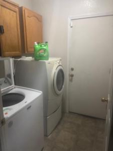 a laundry room with a washing machine and a washer at Master bedroom in Bakersfield +11 photos