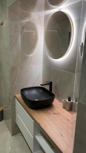 a bathroom with a black sink and a mirror at House Sela vrata in Bibinje