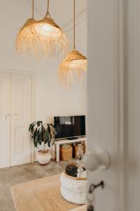 a kitchen with two pendant lights and a table at Casas das Piçarras - Alentejo in Piçarra