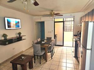 a kitchen and dining room with a table and a refrigerator at Flor del desierto in La Paz