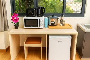a counter with a microwave and a coffee maker on it at Apia Studio w 2 Beds, Secure, AC, Washer, Dryer, Kitchen, WiFi in Apia