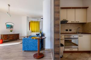 a kitchen and living room with a table with wine glasses at Adrian in Rafailovici +42 photos