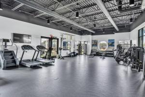 a gym with treadmills and machines in a room at The Well #203 in Zephyrhills