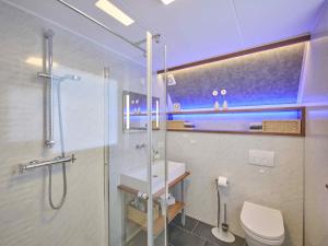 a bathroom with a shower and a toilet and a sink at De Zeediek in Herkingen +82 photos