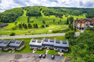 an aerial view of a building with a golf course at Walk to Lift Across from Holiday Valley AC in Ellicottville