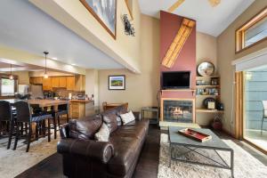a living room with a couch and a fireplace at Walk to Lift Across from Holiday Valley AC in Ellicottville