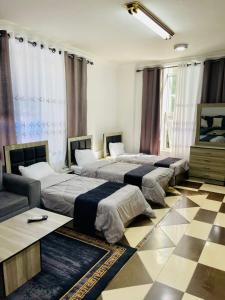 a group of four beds in a room at Al safa in Amman