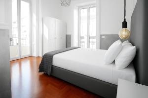 a bedroom with a large white bed with white pillows at Toledostop in Naples