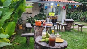 a picnic table with food and a bottle of juice at Village Sapiranga in Mata de Sao Joao