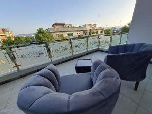 two chairs and a couch on a balcony at Regal Horizon G-13 in Islamabad