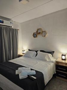 a bedroom with a bed with two towels on it at NICO Apart in Eldorado