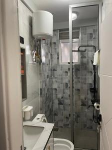 a bathroom with a shower and a toilet and a sink at 3 bedroom 3bathroom apartment at Kingfisher Naalya Estates Kampala, Uganda in Kampala