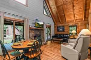 a living room with a table and chairs and a fireplace at Willow Creek cabin in Townsend +28 photos
