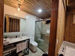 a bathroom with a shower and a toilet and a sink at Cabana em Aguas Mornas in Santo Amaro da Imperatriz +15 photos